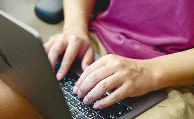 Person typing on laptop