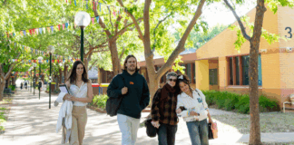 Four students walking around campus