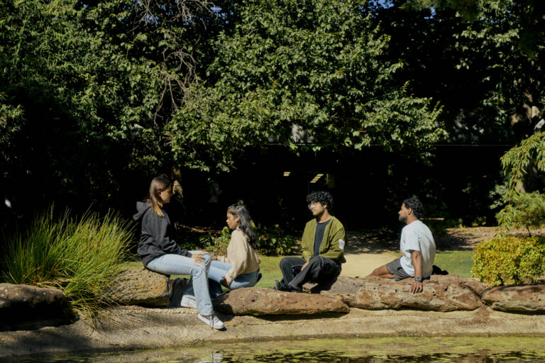 Students sitting at the International Garden at the Bundoora campus