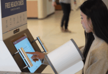 A woman using the SiSU health check machine