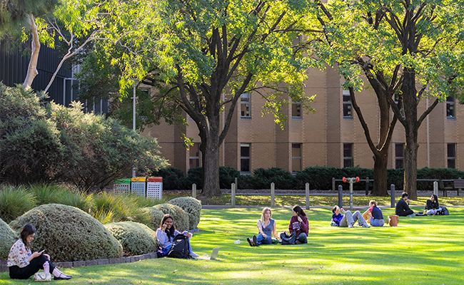 Students sitting on Simpsons Lawn