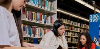 Students looking at books in the library