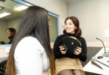 Someone undertaking a hearing test holding headphones