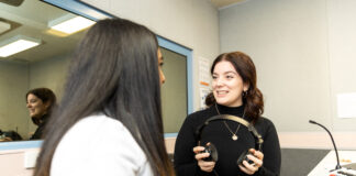 Someone undertaking a hearing test holding headphones