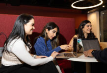 Three students looking at their computers