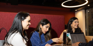Three students looking at their computers