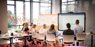Students looking at a screen as part of a hackathon