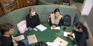 Students studying together at a desk at the Shepparton campus