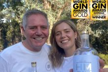 Amy and Gavin with a bottle of award winning gin