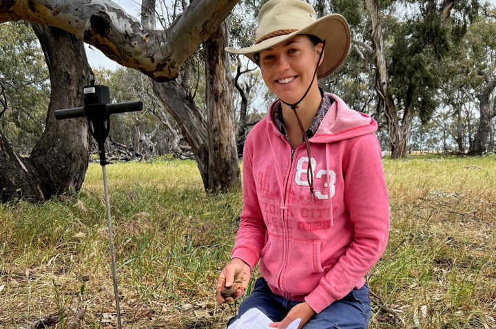 PhD candidate Annette Cavanagh identifying grasses and soil types at a biodiversity site. 
