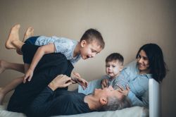 family with child balancing on father's knees