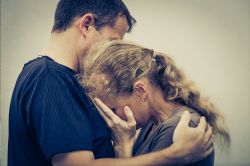 Man comforting distressed woman