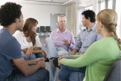 Group of adult family members in discussion around a table