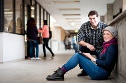 Male and female student looking at the camera and smiling