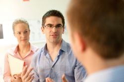 Researchers interacting with staff