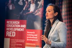   Hannah MacDougall speaking at the 2015 3MT competition