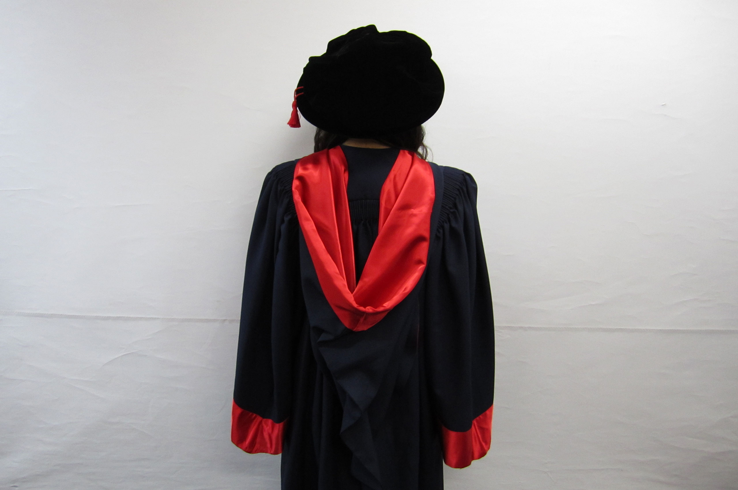 back of professional doctorate gown, deep red silk hood with red silk sleeve cuffs