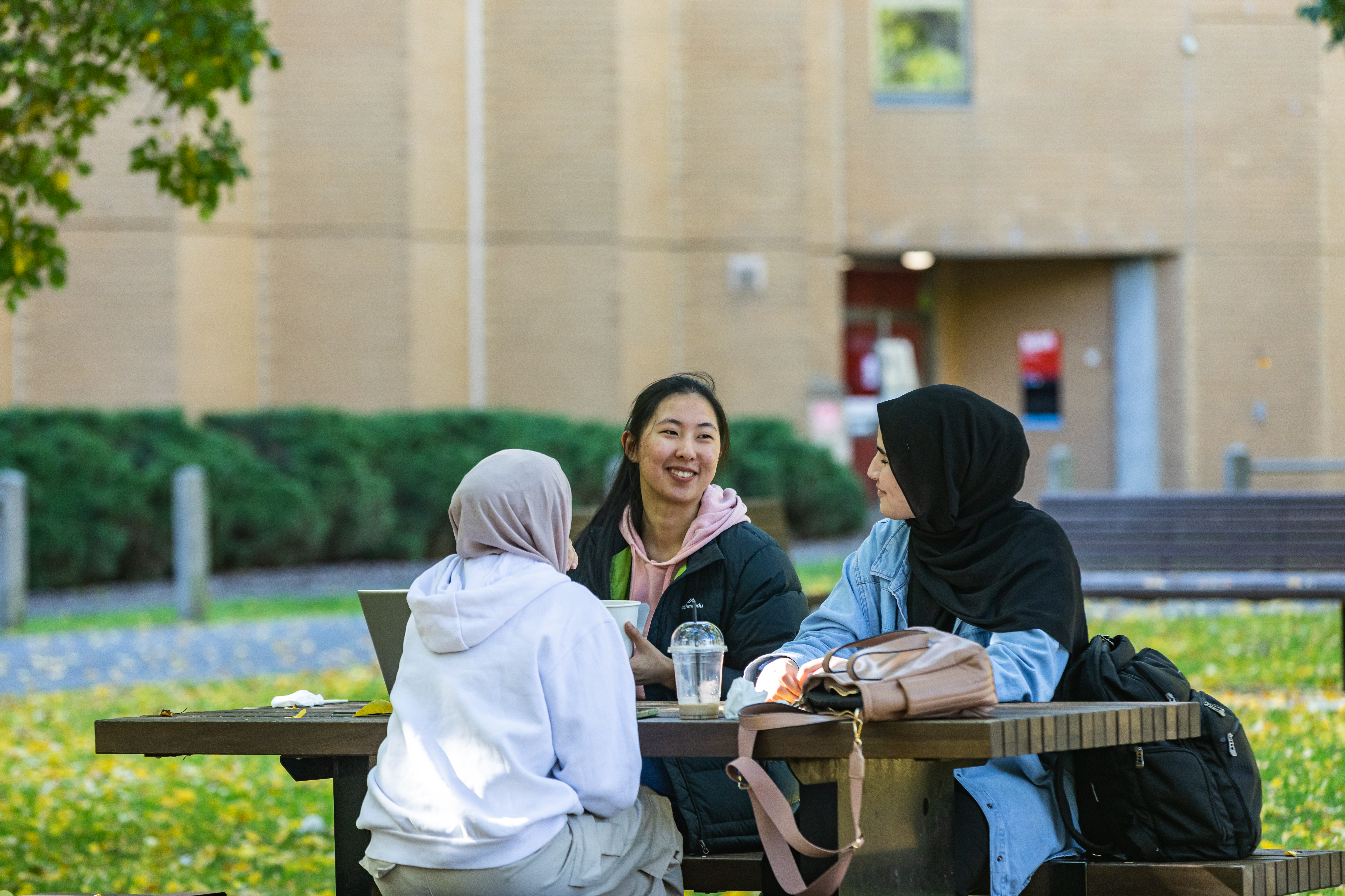 A group of students sitting outdoors at a table