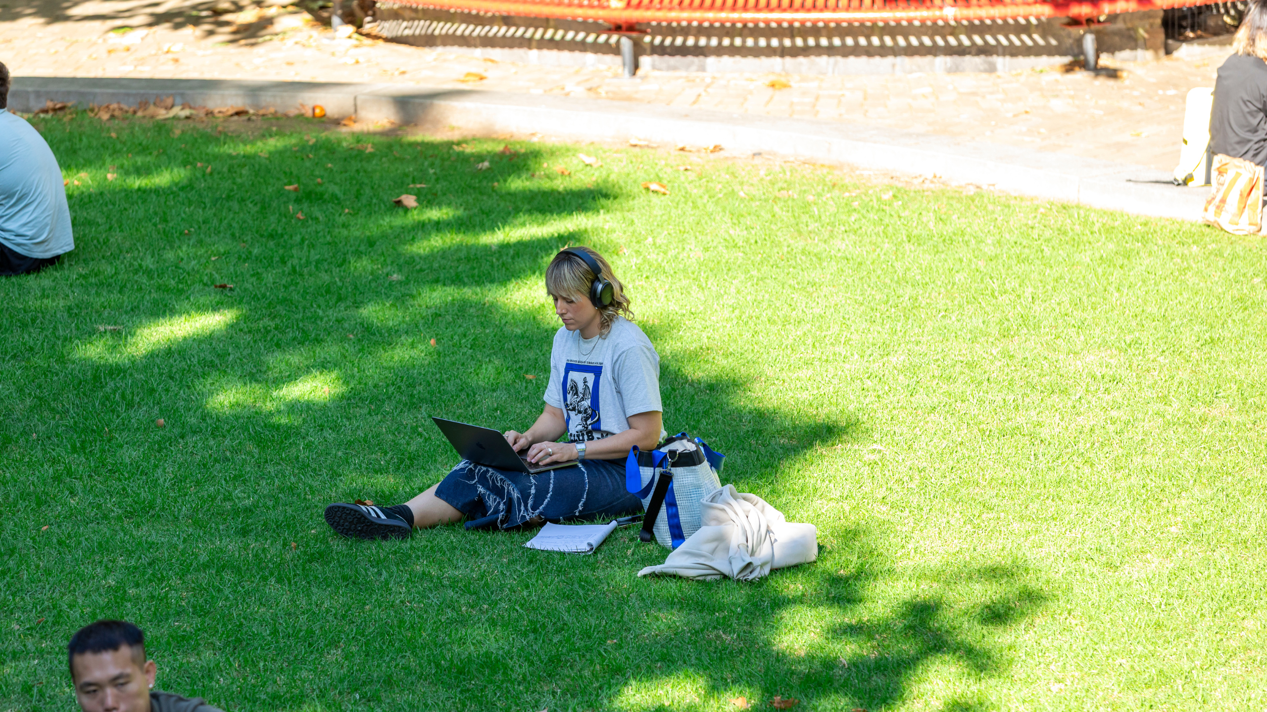 Student on lawn in Agora