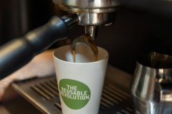 Reusable cup being filled with coffee